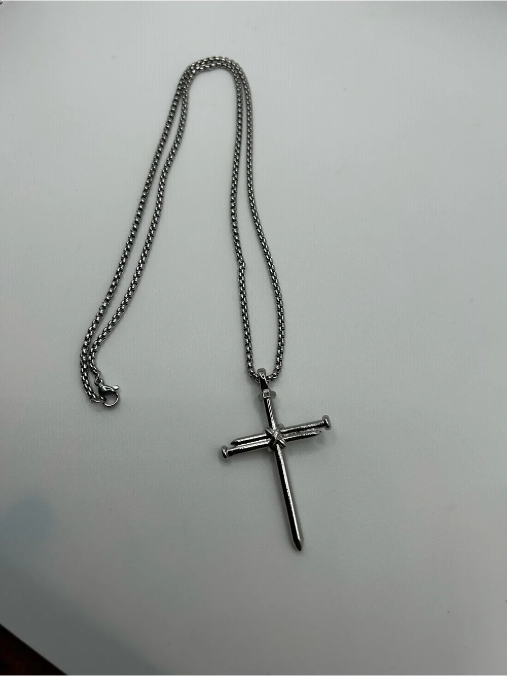Stainless steel cross pendant necklace with textured detail